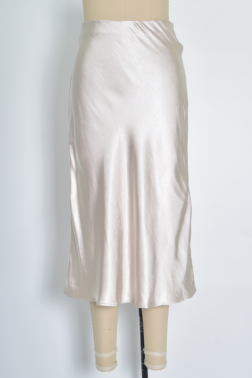 Réf. 41051A - Jupe longueur midi à la coupe évasée. Taille plate sans ceinture apparente pour un fini épuré. Matière satinée offrant un tombé souple et élégant. Fermeture discrète sur le côté.