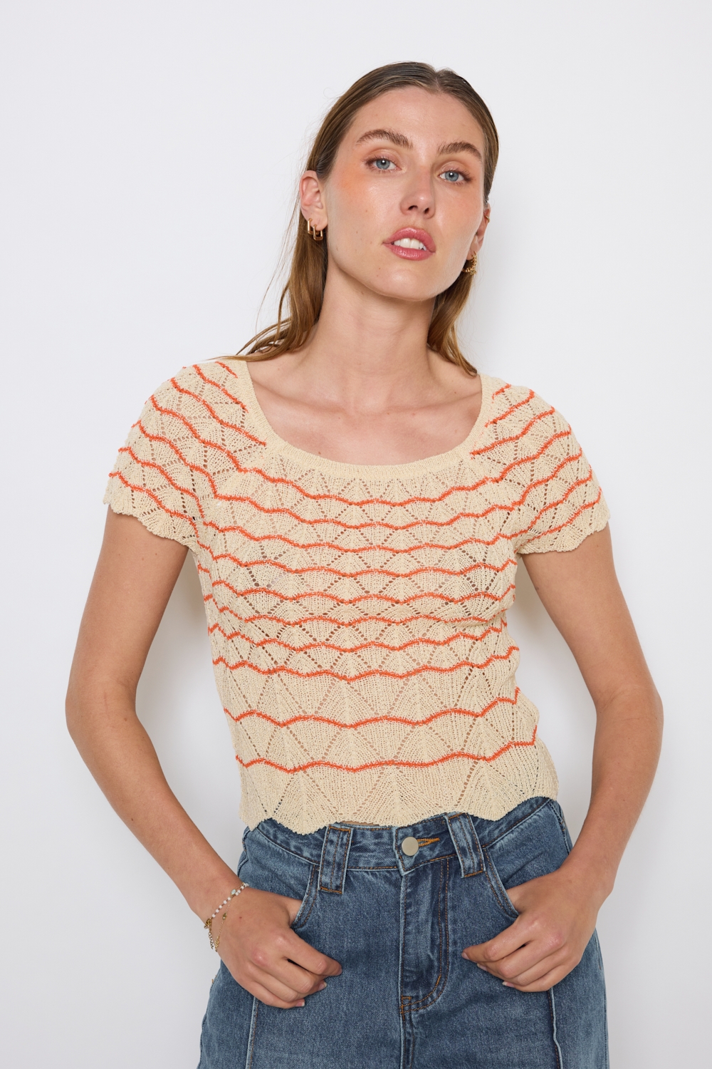 Réf. 47015A - Top ajusté avec encolure ronde dégagée et manches courtes. Tricot ajouré avec motifs en relief réguliers. Finition côtelée discrète à la base et aux manches.